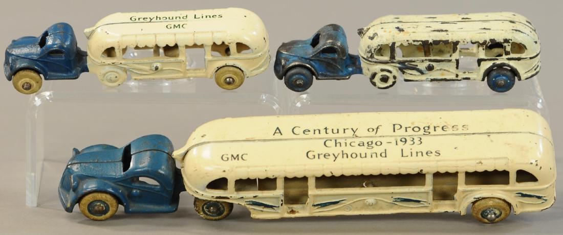 LOT OF THREE GREYHOUND BUSES: 1057. LOT OF THREE GREYHOUND BUSES | Two GMC, one Century of Progress Semi bus. | 10" l. | Small unmarked example is repainted, others are in All Original Condition. | $150 - $300