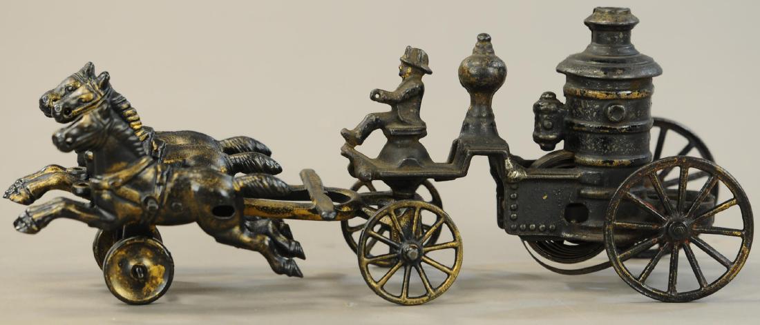 CAST IRON CLOCKWORK FIRE PUMPER: 1073. CAST IRON CLOCKWORK FIRE PUMPER | 13.5" l. | Mismatched front and back ends, front end is Hubley, back end has repaint and is probably Ives. | $200 - $400
