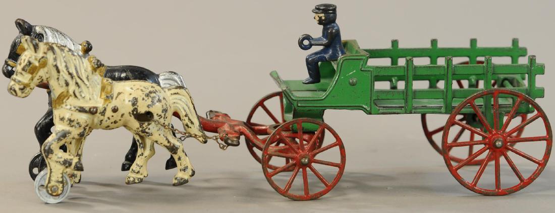 MEDIUM SIZED KENTON HORSE DRAWN STAKE WAGON: 1074. MEDIUM SIZED KENTON HORSE DRAWN STAKE WAGON | 14.5" l. | One replaced wheel on horse. | $100 - $200