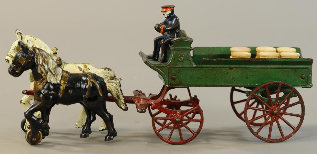 KENTON HORSE DRAWN DELIVERY WAGON: 1075. KENTON HORSE DRAWN DELIVERY WAGON | 14.5" l. | Two front wagon wheels broken in half, incorrect figure. | $100 - $200