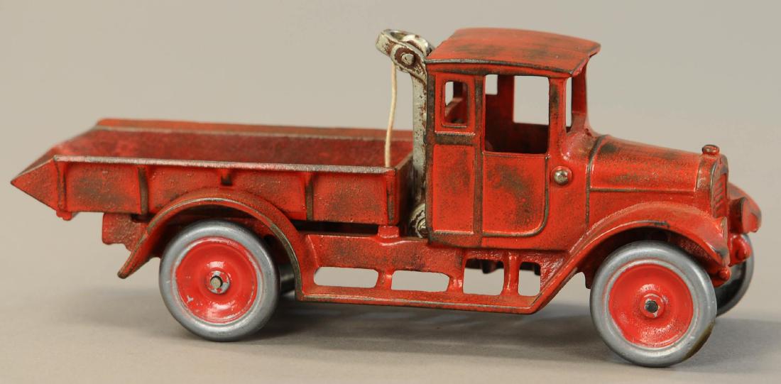 ARCADE IH RED BABY DUMP TRUCK: 1108. ARCADE IH RED BABY DUMP TRUCK | 10.5" l. | Repainted with replaced wheels and dump bed mechanism. | $150 - $300