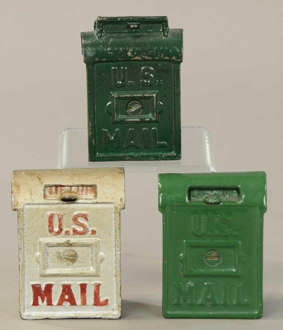 THREE SAFE STILL BANKS: 1282. THREE SAFE STILL BANKS | Lot includes; US mail Ohio foundry, US mail bank, and Silver US mail bank. | 3" - 5" h. | All Original Condition. | $50 - $100