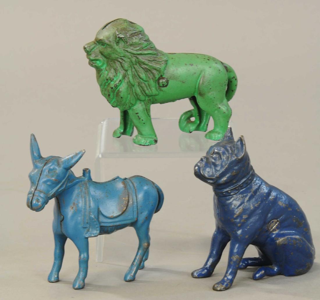 THREE ARCADE PAINTED ANIMAL STILL BANKS: 1286. THREE ARCADE PAINTED ANIMAL STILL BANKS | Lot includes; Green lion, Light blue donkey, Blue seated boxer banks. | 3.5" - 4.5" h. | All Original Condition. | $100 - $200