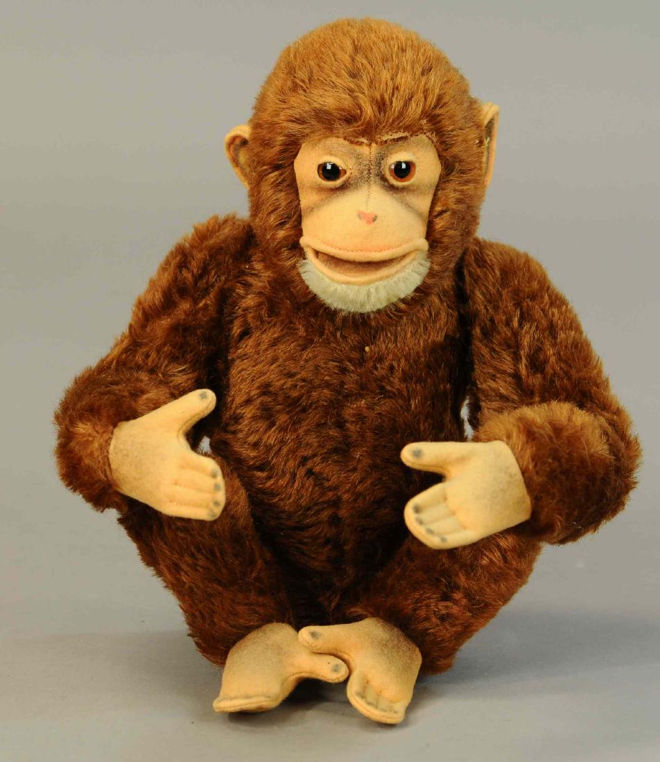 SITTING STEIFF MONKEY: 1317. SITTING STEIFF MONKEY | Beautiful example with button and remnant of yellow tag, airbrushing on face, hands, feet and face prominent. | 13" | (Pristine Cond.) | $100 - $200