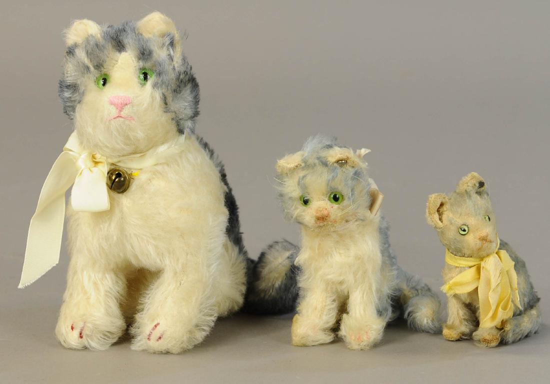 LOT OF THREE STUFFED TOY CATS: 1320. LOT OF THREE STUFFED TOY CATS | Bing cat w/squeaker, (Mint Cond.); smaller Steiff cat w/early button, circa 1930; and later Steiff cat, circa 1950; all with tipped fur. | Bing Cat 8.5" | Overall