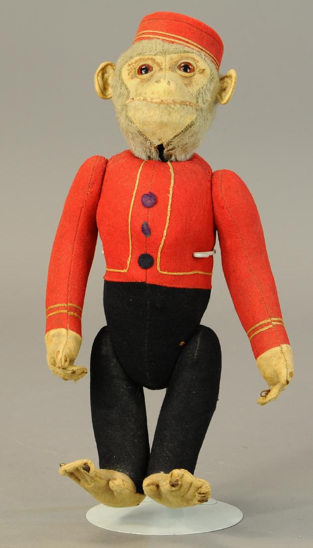 BELL HOP SCHUCO MONKEY: 1325. BELL HOP SCHUCO MONKEY | Nice example of yes/no mechanical monkey, some staining to face, feet and hands show wear, overall good color and working mechanics. | 12" | (VG-Exc. Cond.) | $75 - $150