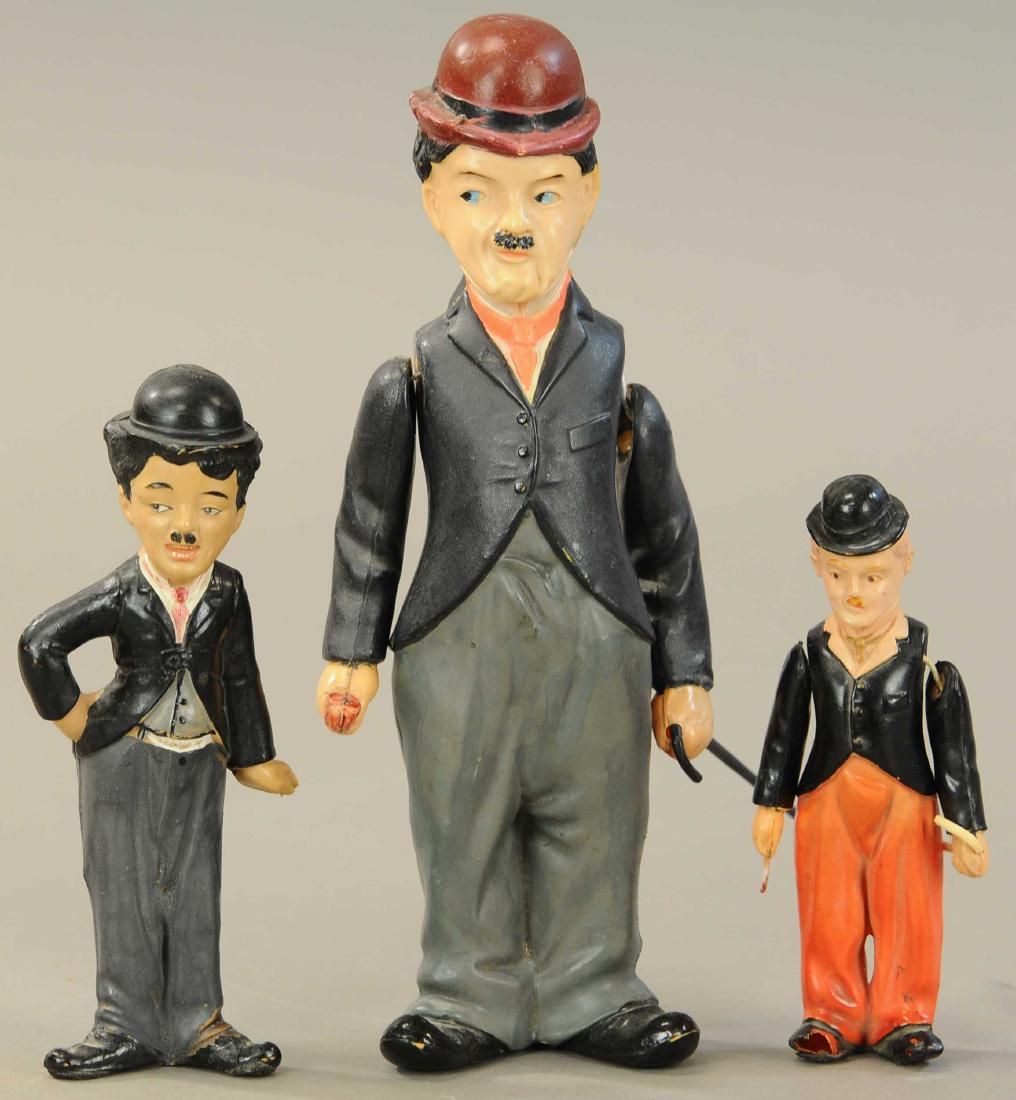 THREE CELLULOID CHARLIE CHAPLIN FIGURES: 50. THREE CELLULOID CHARLIE CHAPLIN FIGURES | 10" h. | All Original Condition. | $150 - $300