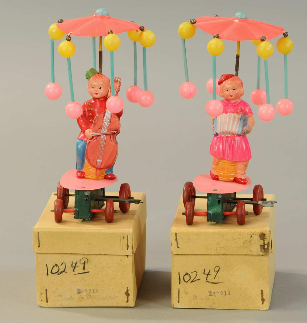 TWO BOXED MECHANICAL CELLULOID WHIRLIGIG TOYS: 60. TWO BOXED MECHANICAL CELLULOID WHIRLIGIG TOYS | 7" h. | All Original Condition. | $250 - $500