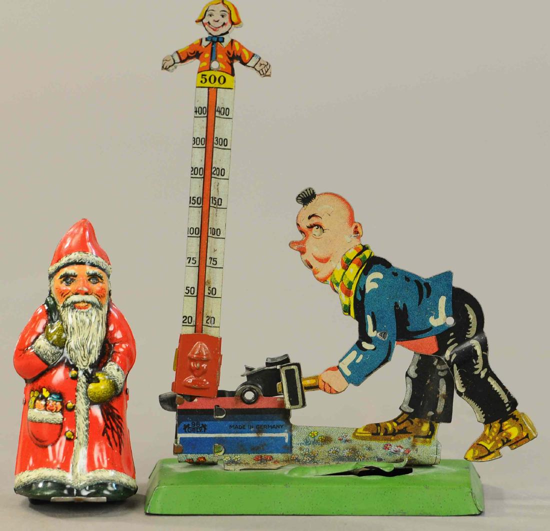 ARNOLD WIND-UP SANTA & GELY CARNIVAL CLICKER TOY: 67. ARNOLD WIND-UP SANTA & GELY CARNIVAL CLICKER TOY | Carnival game is spring loaded with button to release his foot. | 7" h. | All Original Condition. | $200 - $400
