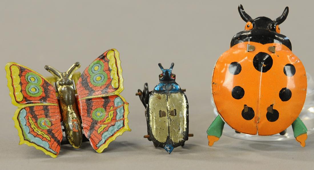 LOT OF THREE INSECT PENNY TOYS: 79. LOT OF THREE INSECT PENNY TOYS | Large orange beetle is missing its front legs. | 3" h. | As noted, otherwise All Original Condition. | $50 - $100