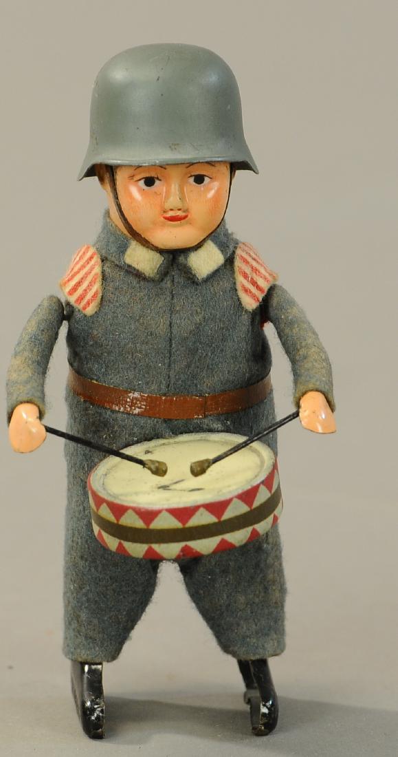 SCHUCO GERMAN SOLDIER DRUMMER: 99. SCHUCO GERMAN SOLDIER DRUMMER | 5" h. | All Original Condition. | $150 - $300