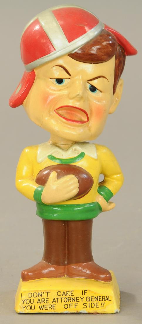 JOHN F. KENNEDY FOOTBALL BOBBLEHEAD: 165. JOHN F. KENNEDY FOOTBALL BOBBLEHEAD | 6.75" h. | Small dent at top of helmet, some crazing to head overall. | $250 - $500