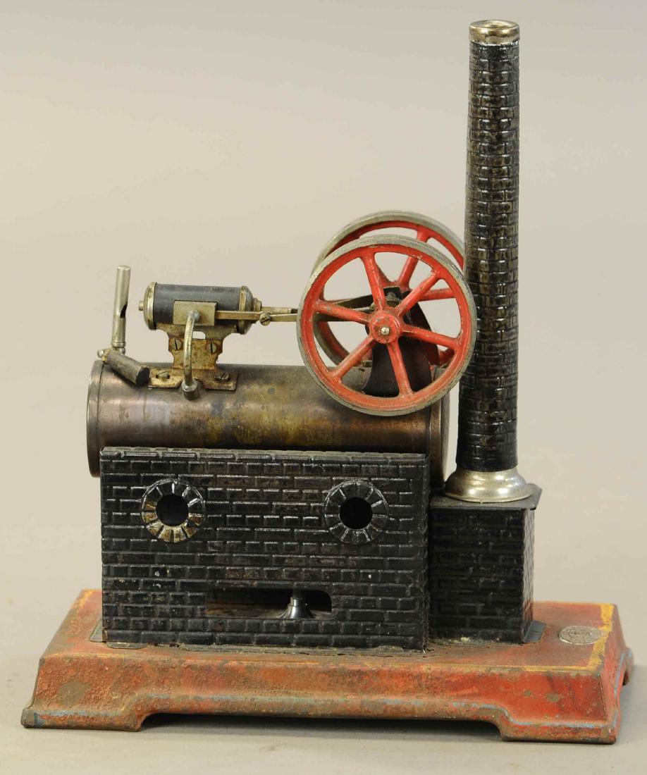 JF JON FALK OVERTYPE STEAM ENGINE: 409. JF JON FALK OVERTYPE STEAM ENGINE | circa 1925, twin flywheels original condition with burner and stack. | Base 9" x 5" x 11" h. | All Original Condition. | $100 - $200
