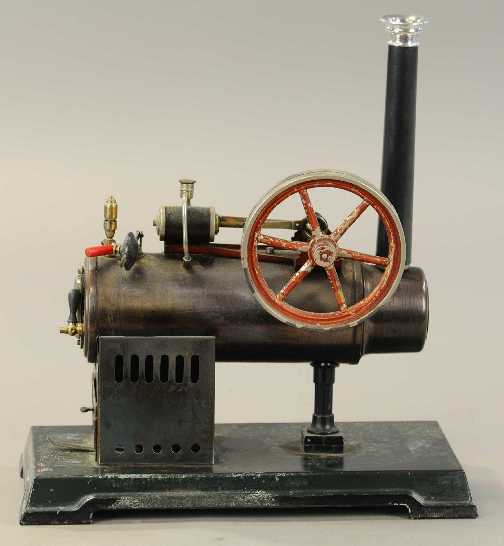 BING LOCOMOBILE STEAM ENGINE: 412. BING LOCOMOBILE STEAM ENGINE | circa 1913, #130/584, burnished boiler, 5.5" flywheel, inline oiler, lower pressure gauge, whistle water lever glass, drain cock, burner, funnel, box & paperwork. |