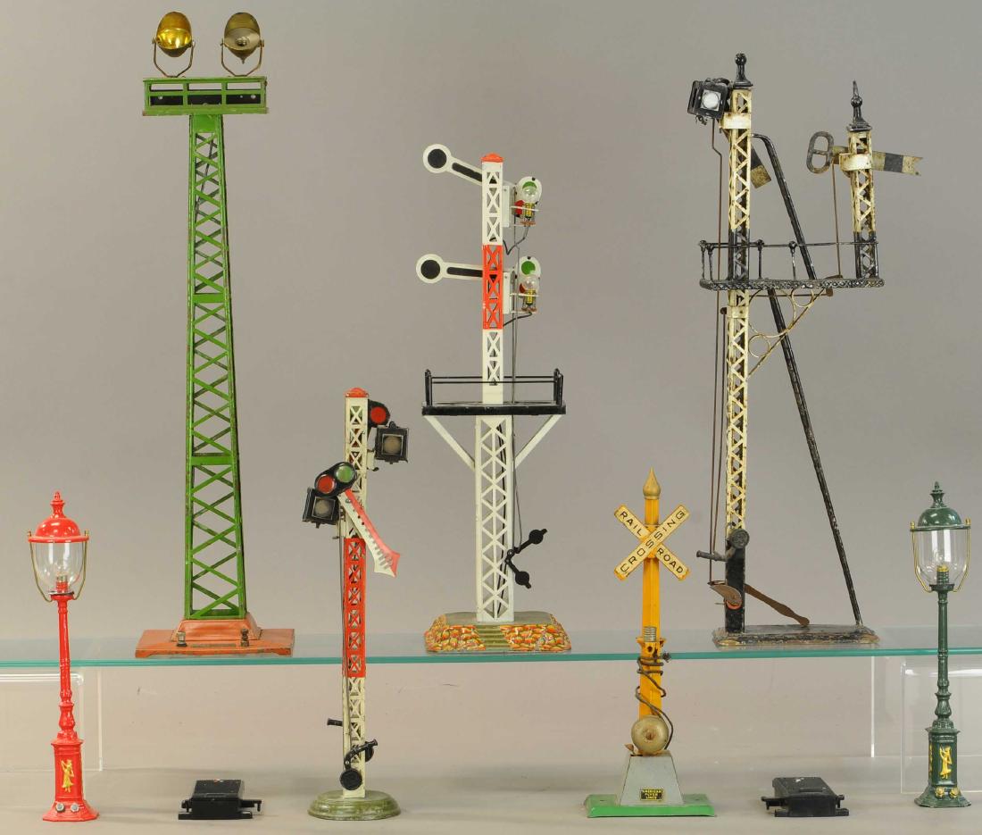 GROUP OF BING, FLYER & PRIDE LINES TRAIN ACCESS: 425. GROUP OF BING, FLYER & PRIDE LINES TRAIN ACCESS | Pride Lines lamps, three Bing semaphores, American Flyer signal, and Lionel floodlight tower, two LGB controllers. | Tallest 20" h. | Two lamp po
