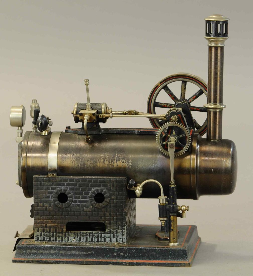 JF JON FALK LOCOMOBILE STEAM PLANT: 436. JF JON FALK LOCOMOBILE STEAM PLANT | circa 1925, #473, burnished boiler 8.5" x 3.5", heavy 3.5" flywheel, water sight glass, pressure gauge, whistle, lever pressure valve, water pump and bucket, 