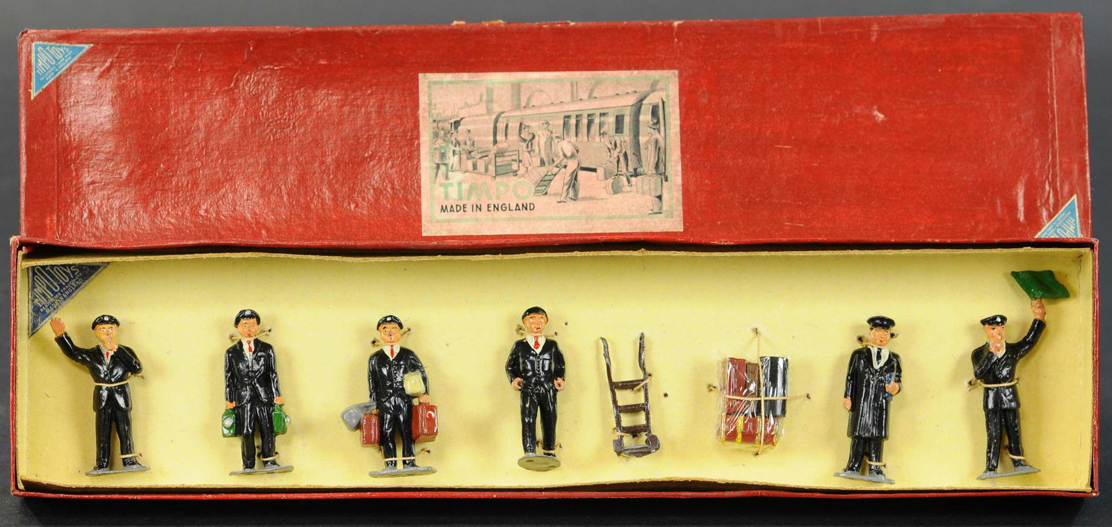 TIMPO #800 RAILWAY FIGURES: 97. TIMPO #800 RAILWAY FIGURES | Station personnel with porters, cart and luggage. | 54mm. | Box (Excellent Condition), figures (Near Mint Condition) | $150 - $250