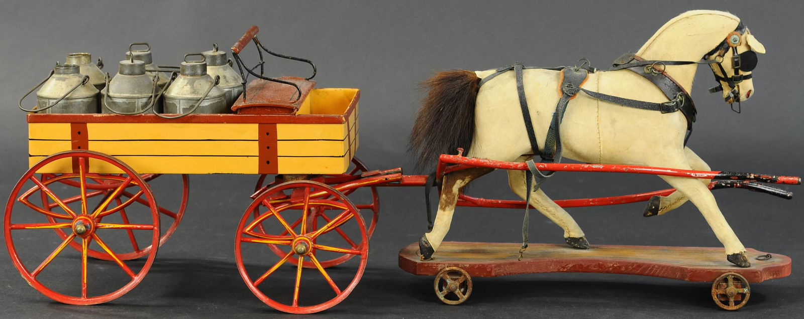 OVERSIZED MARKLIN DELIVERY WAGON: 213. OVERSIZED MARKLIN DELIVERY WAGON | Brightly hand painted in red and yellow hues, very large scale. | Carriage & hitch 23.5 length. | Solder seam on rear left axle is split, some minor reinforceme