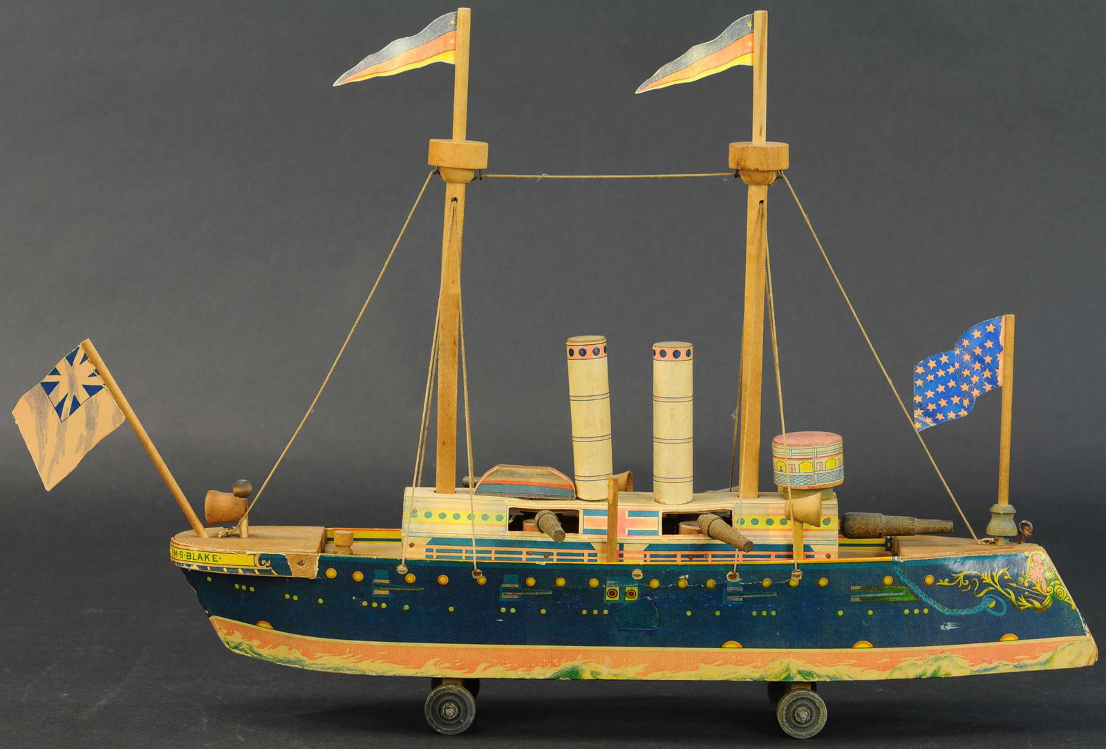 HMS BLARE BATTLESHIP: 344. HMS BLARE BATTLESHIP | Attributed to Reed Mfg. based on style of lithography, as with many of these ships, the decking lifts to allow storage of all pieces and parts. | 18.5" length. | Small touc