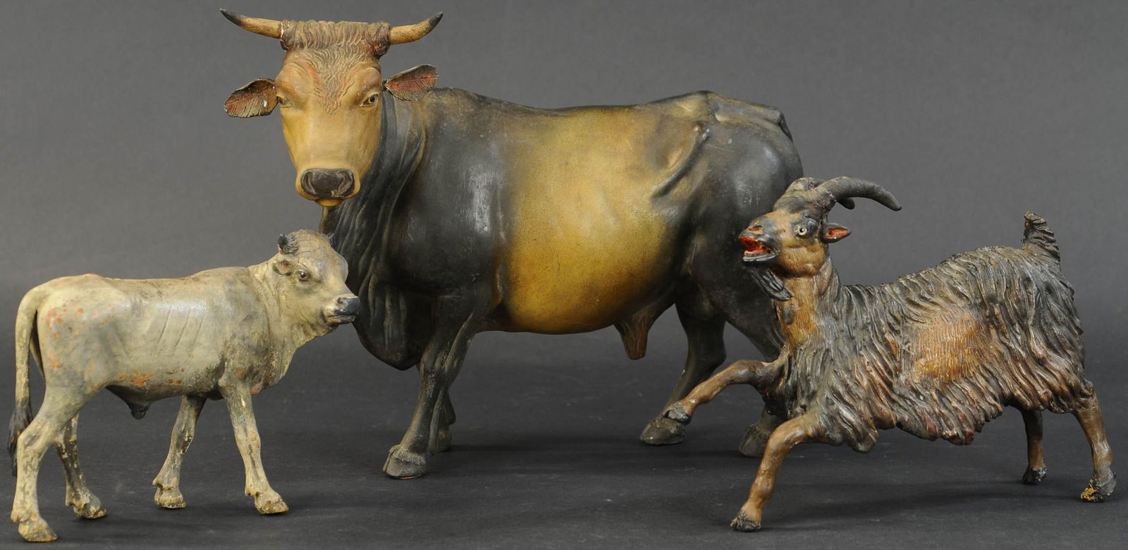 GOAT, COW, AND BULL CRECHE FIGURES: 474. GOAT, COW, AND BULL CRECHE FIGURES | Redware/chalk animals, very well detailed and quite early with glass eyes in all. | 7.5"-13" length. | Bull & goat have ears & horns re-glued, some very minor