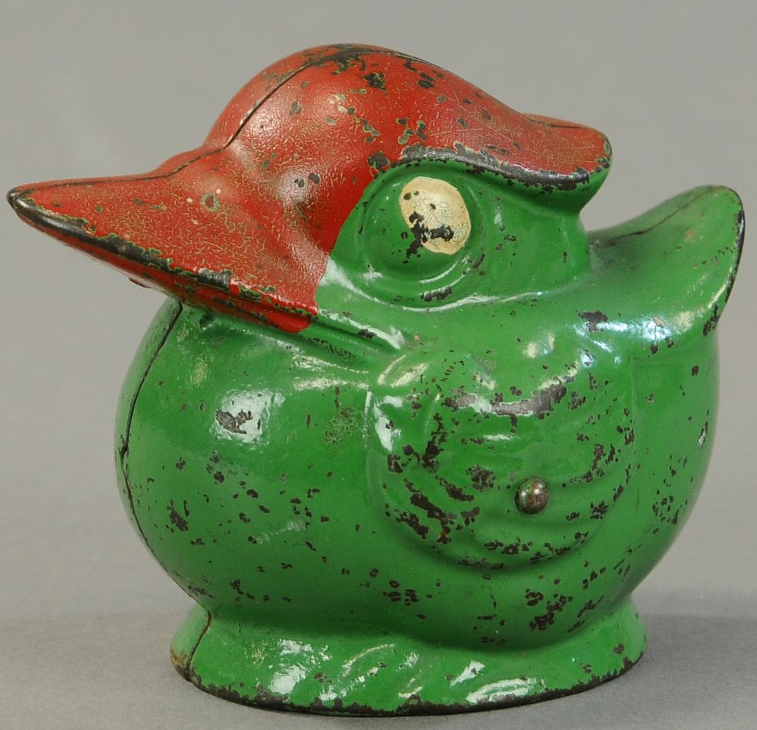 KENTON GREEN ROUND DUCK STILL BANK: 20. KENTON GREEN ROUND DUCK STILL BANK | 4" h. | Two holes drilled in base of bank, replaced trap, (Exc. Cond.) | $200 - $400