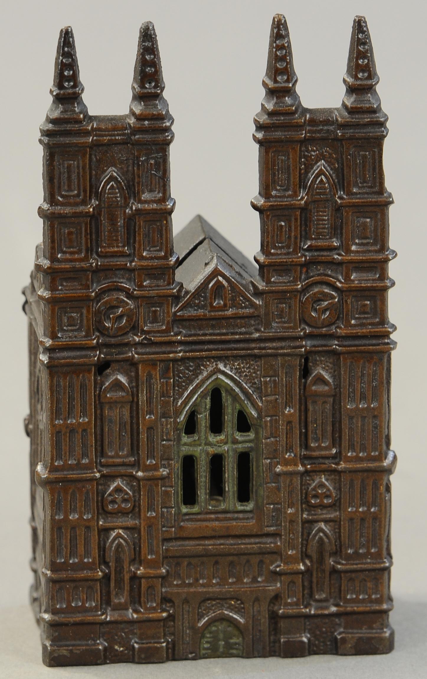 WESTMINSTER ABBEY STILL BANK: 26. WESTMINSTER ABBEY STILL BANK | England, attributed to Sydenham & McOustra, scarce version of the bank with squared back and pointed finials. 6.25" h. | (Near Mint Cond.) | $700 - $1,000