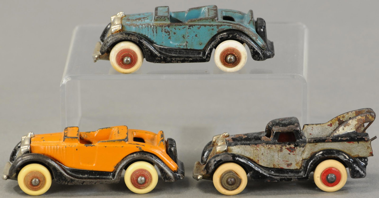 THREE HUBLEY NICKEL GRILLE AUTOS: 409. THREE HUBLEY NICKEL GRILLE AUTOS | 4" l. | Wrecker truck is overpainted, others in (VG Cond.) with some wheels replaced. | $300 - $500