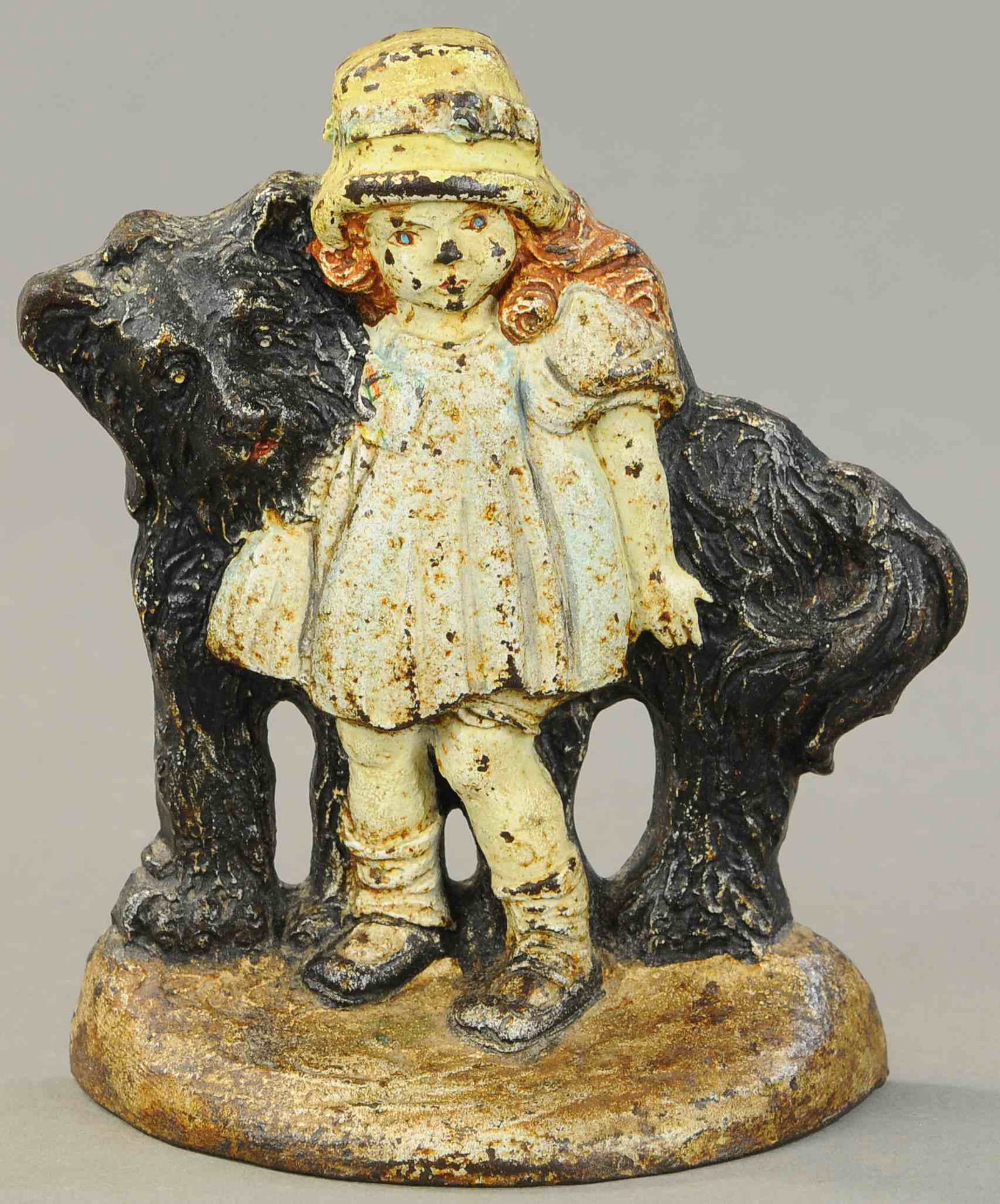 GIRL WITH SHAGGY DOG DOORSTOP: 450. GIRL WITH SHAGGY DOG DOORSTOP | Marked "Bronze Products Society, Inc.," whimsical example of girl standing by her large dog seemingly watching over her, a charming and rare piece. 7" h. | (VG Con