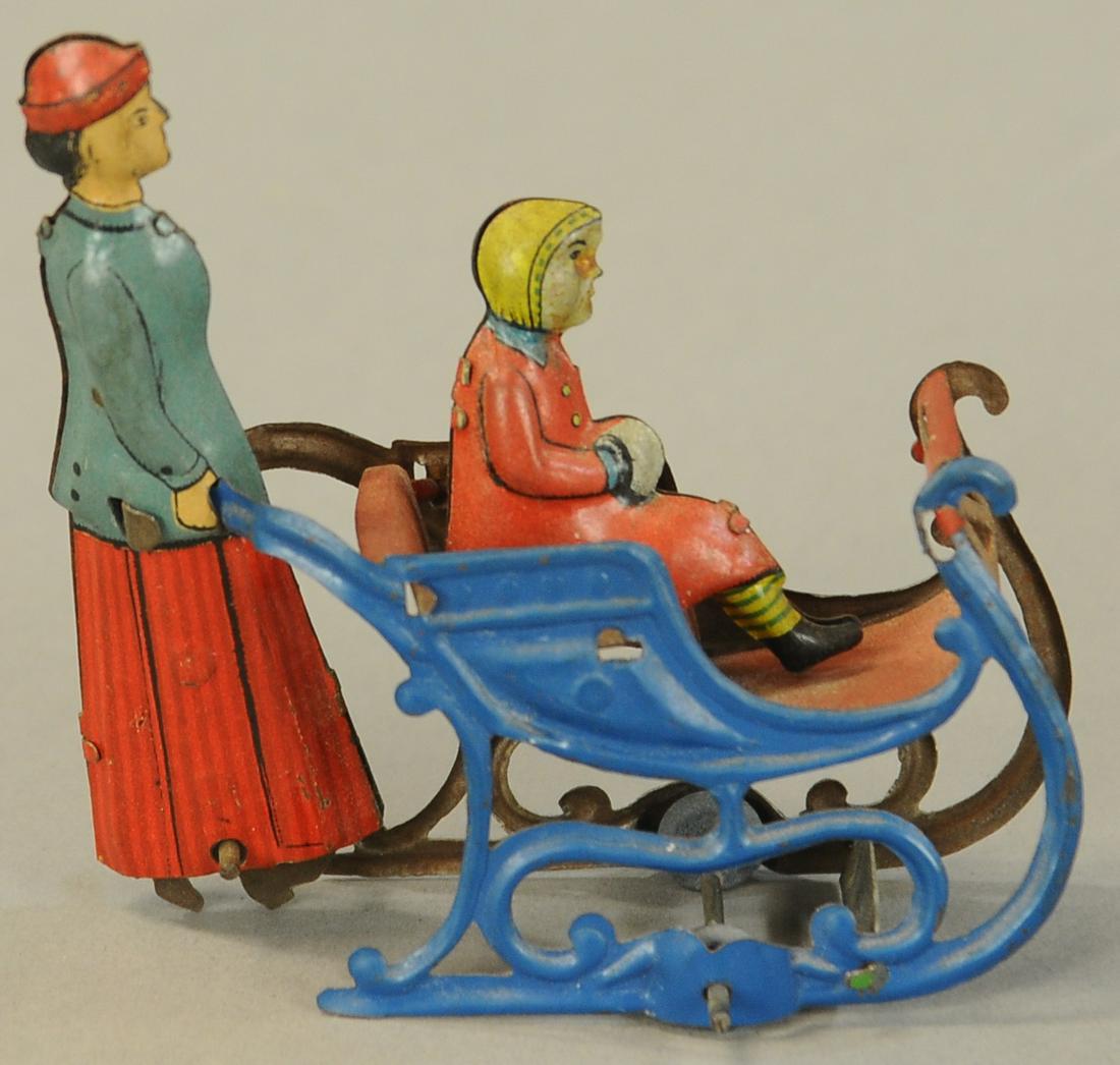 WOMAN PUSHING CHILD IN SLEIGH PRAM PENNY TOY: 1046. WOMAN PUSHING CHILD IN SLEIGH PRAM PENNY TOY | Meier, interesting to note the juxtaposed lithography on the mother, one side she is pushing the pram while on the other side the litho is reversed