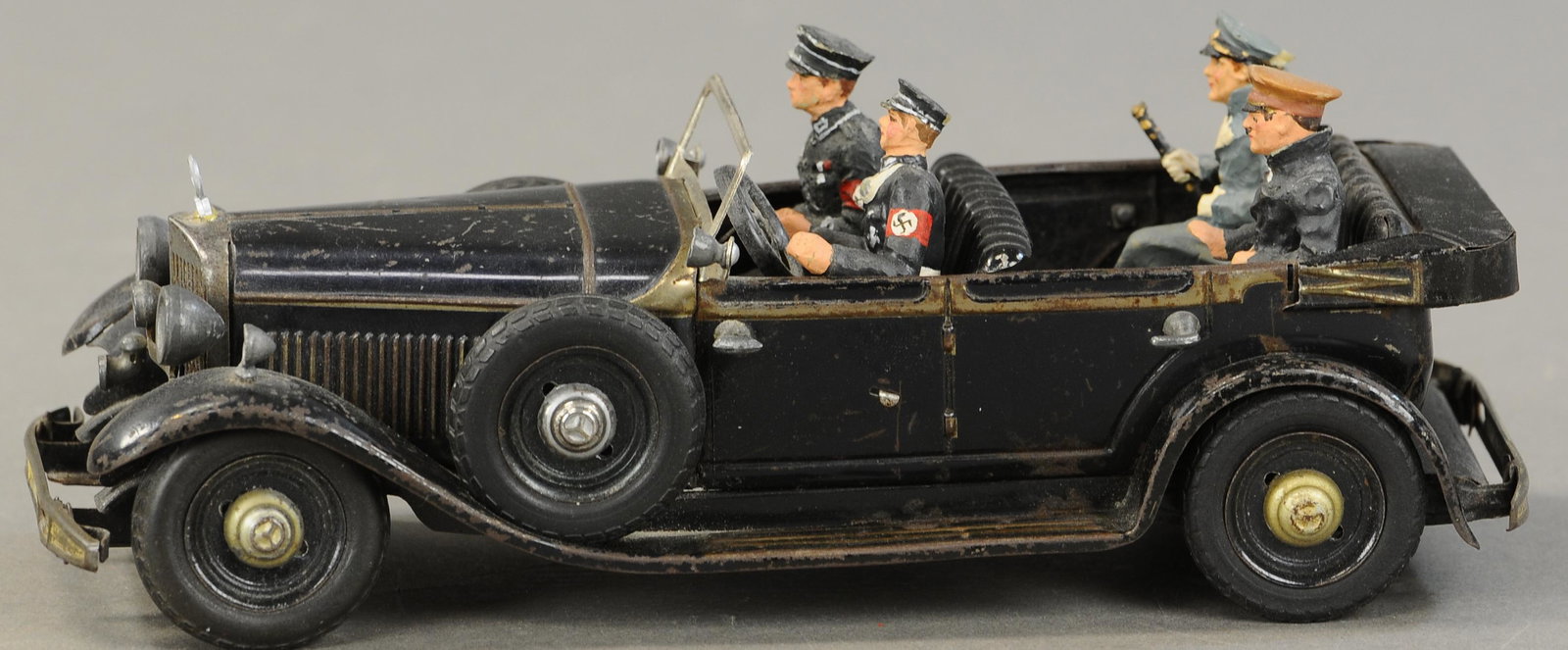 TIPPCO HITLER'S MERCEDES AUTO: 1072. TIPPCO HITLER'S MERCEDES AUTO | Black version, elaborate toy version of the Fuhrer's personal vehicle, comes with four added figures. 9" l. | Small touch-up to one front fender, overall (VG Cond