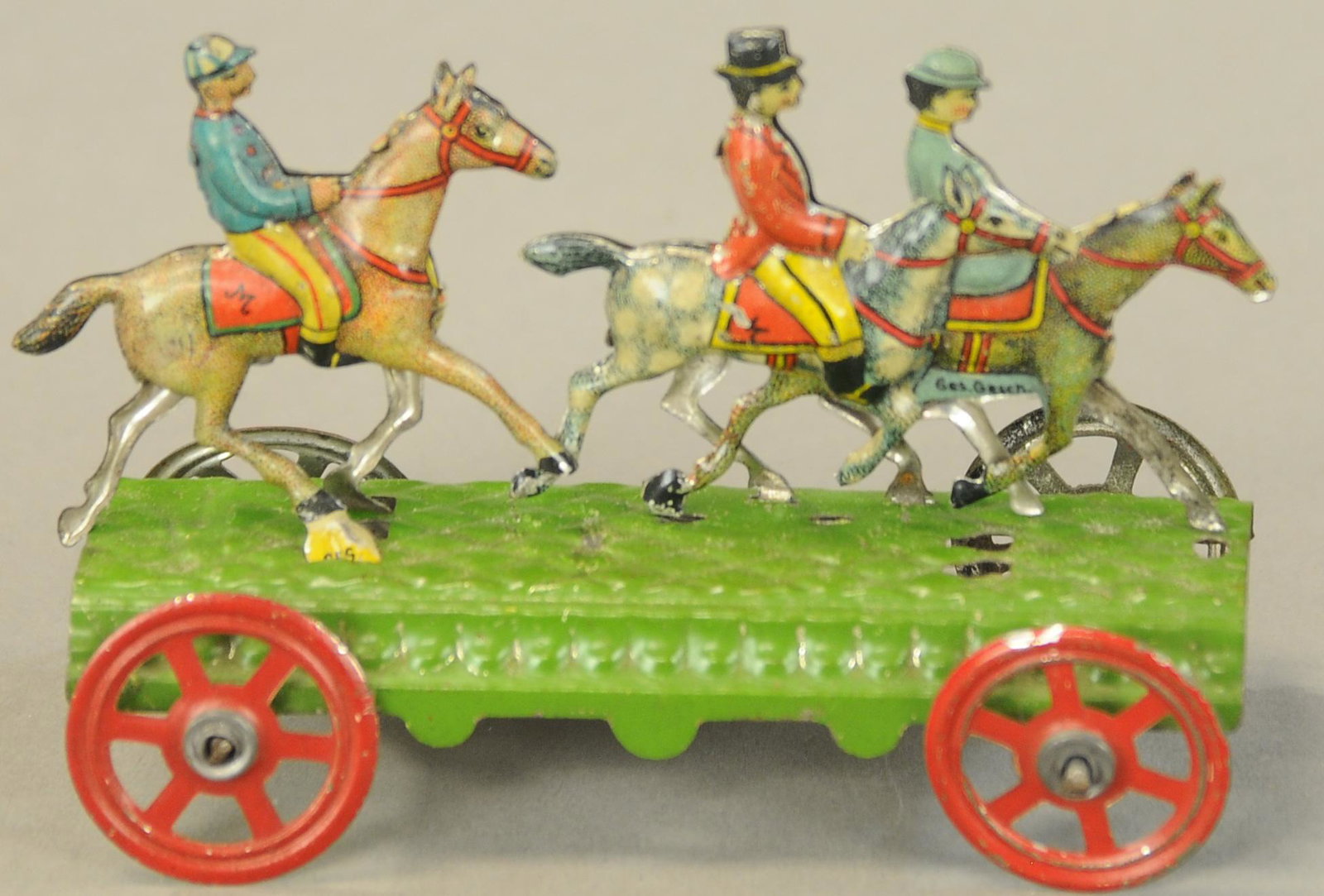 MEIER A HORSE RIDE PENNY TOY: 1136. MEIER A HORSE RIDE PENNY TOY | Charming toy, couple riding at front with jockey at rear. 3.5" l. | (Pristine Cond.) | $400 - $600