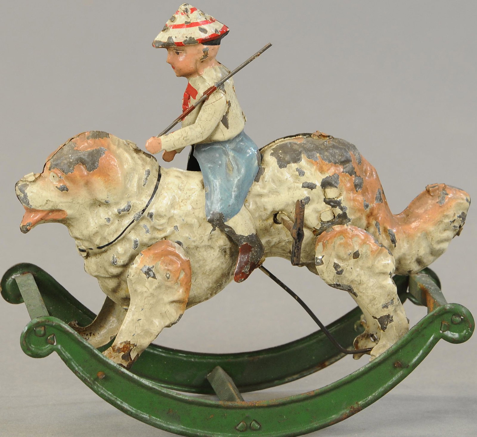 SOLDIER BOY ON DOG ROCKER: 1250. SOLDIER BOY ON DOG ROCKER | Germany, attributed to Mangold, charming little toy of soldier boy riding on a rocking dog. 7 " | (Exc. Cond.) | $600 - $800