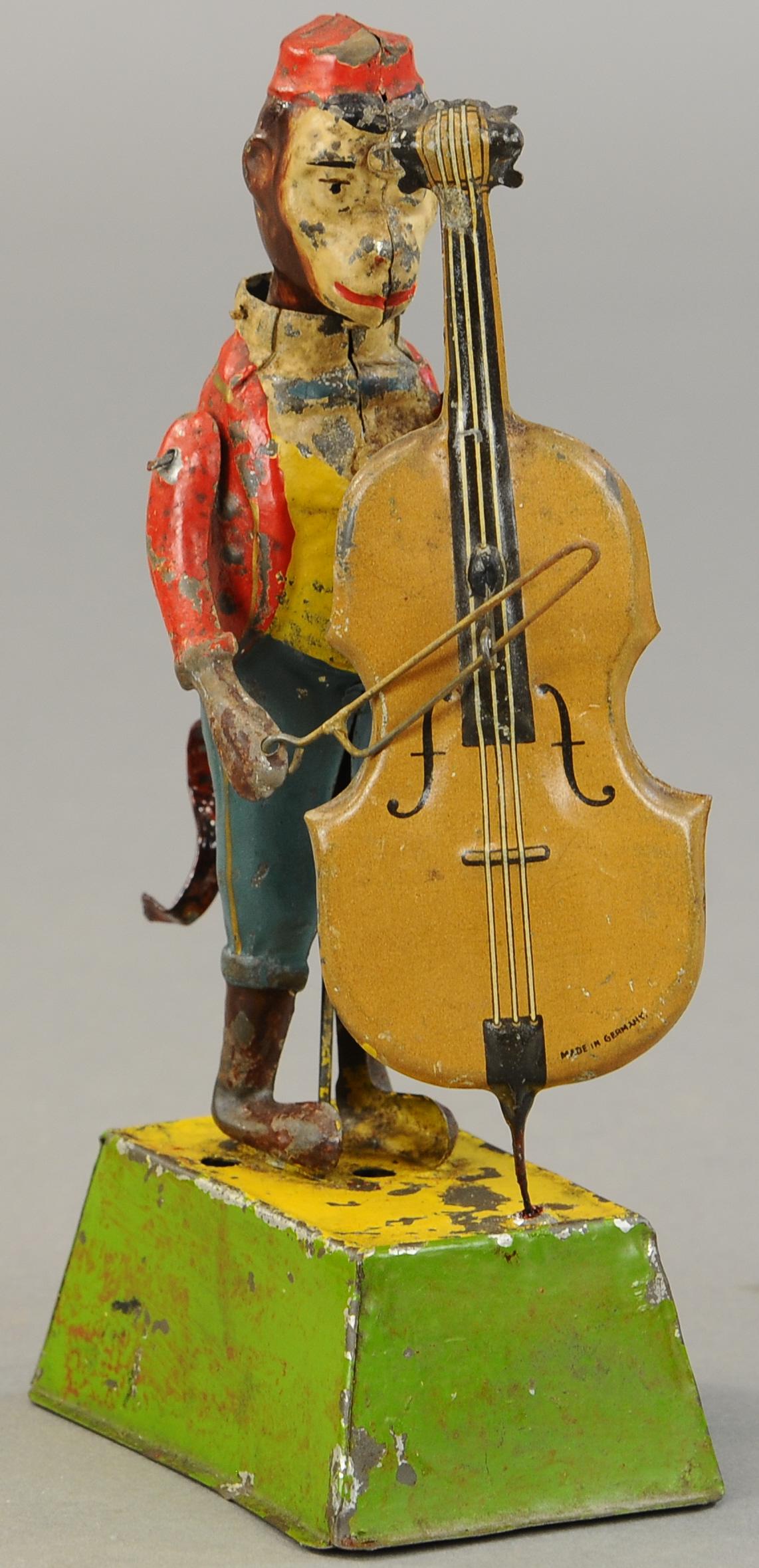 GUNTHERMANN MONKEY W/ CELLO: 1264. GUNTHERMANN MONKEY W/ CELLO | A cute piece, clockwork driven with sound and motion. 9 " | Tail replaced, otherwise in (VG Cond.) | $700 - $1,000