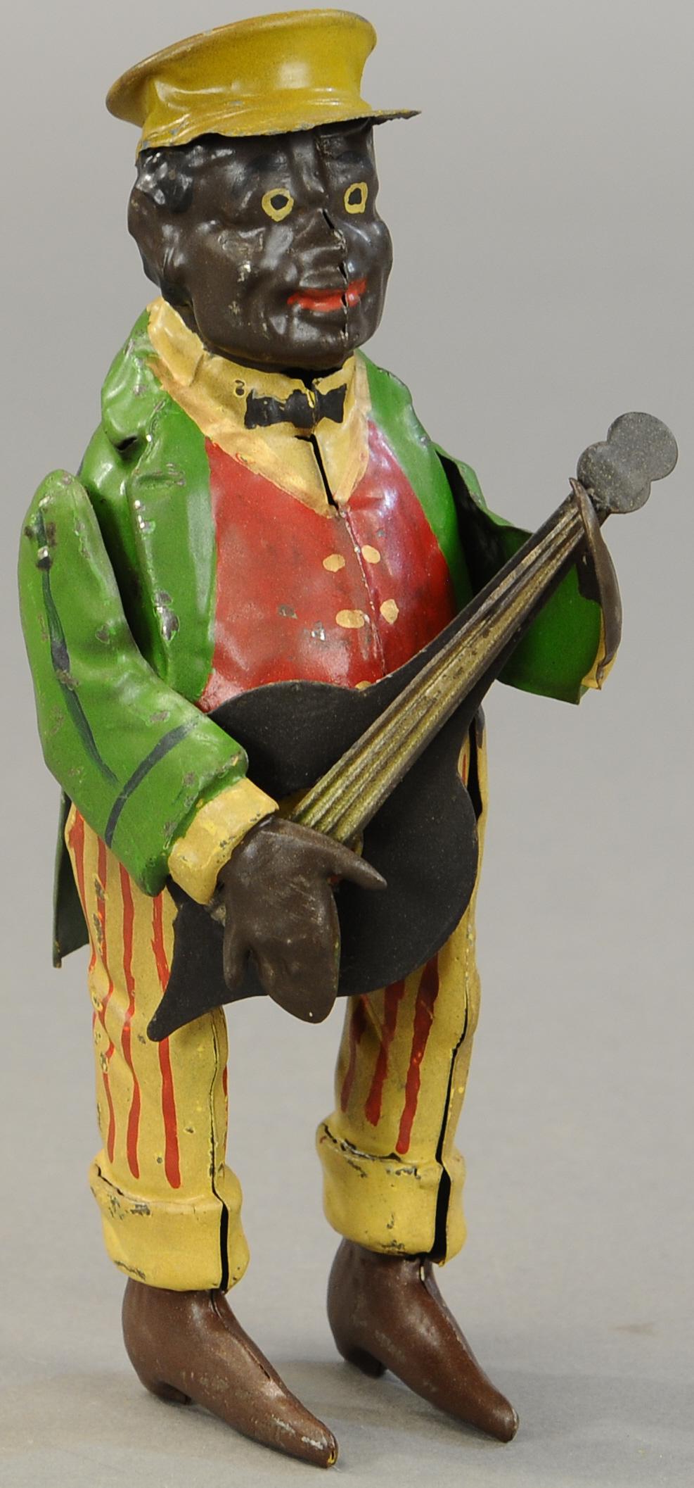 BLACK MAN BANJO PLAYER: 1266. BLACK MAN BANJO PLAYER | Germany, possibly made by Mueller & Kadeder. 8 " | Restored. | $700 - $1,000