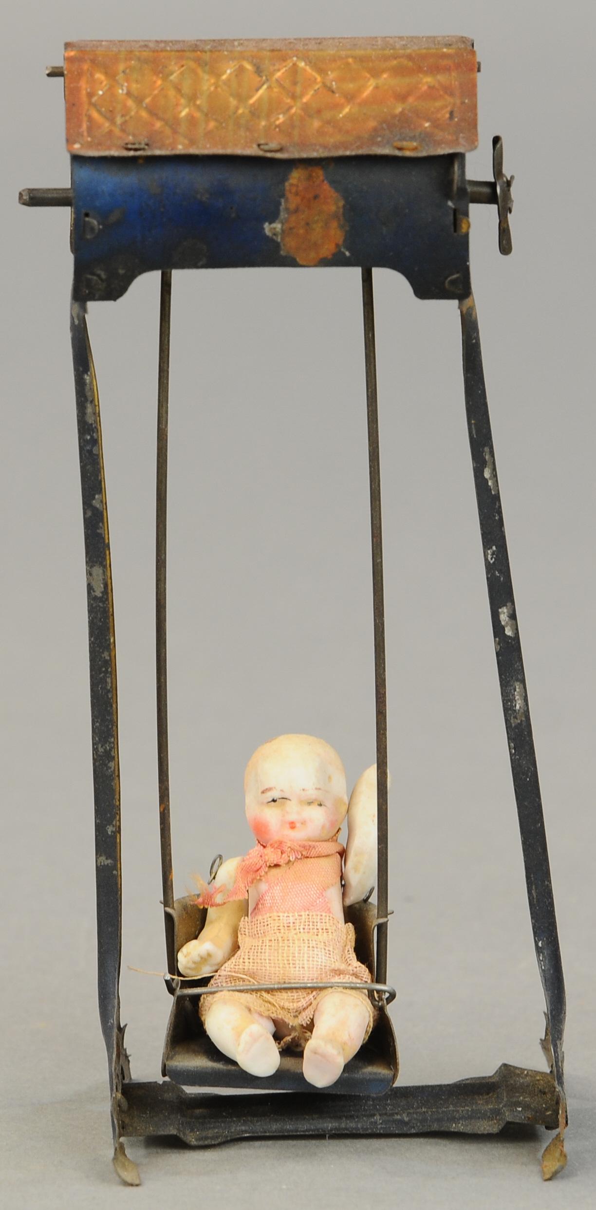 LEHMANN DOLL IN SWING: 1275. LEHMANN DOLL IN SWING | A very scarce example for advanced collections, wind-up causes doll to rock back and forth in swing. 7" | (Very Good Cond.) | $2,000 - $3,000
