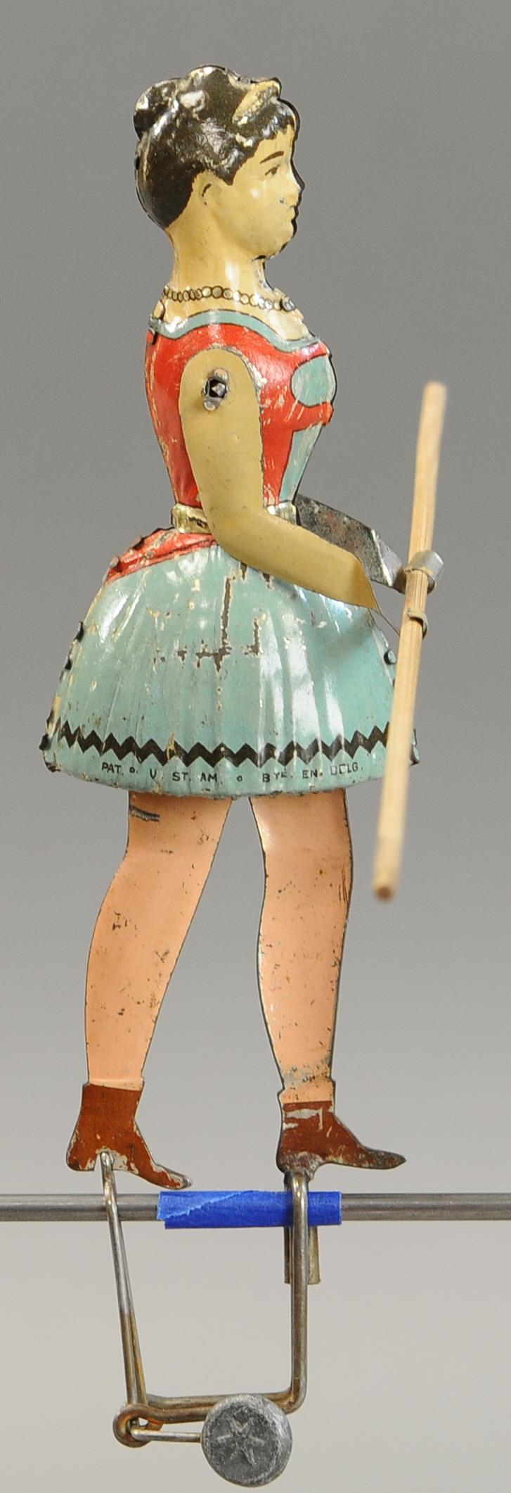 LEHMANN MISS BLONDIN TIGHT ROPE WALKER: 1276. LEHMANN MISS BLONDIN TIGHT ROPE WALKER | Popular and quite scarce, balancing act gravity toy. 14" h. | (Exc. Cond.) | $1,000 - $1,400