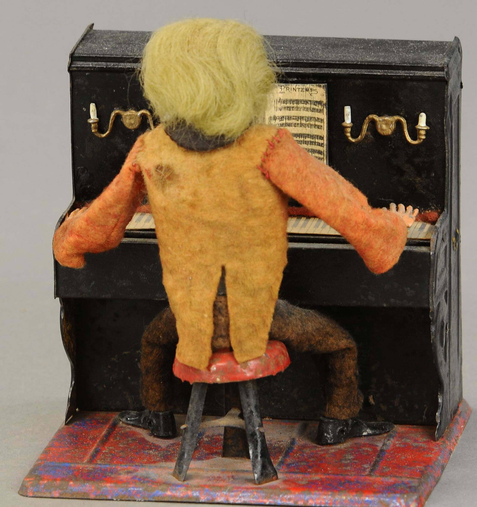FERNAND MARTIN PIANIST: 1301. FERNAND MARTIN PIANIST | "Le Petit Pianiste" c. 1902, early toy depiction of seated man at the piano which actually plays sound. 5" | (Exc. Cond.) | $1,000 - $1,400