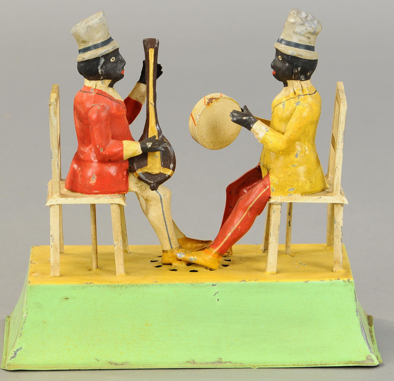 GUNTHERMANN JAZZ MUSICIANS: 1307. GUNTHERMANN JAZZ MUSICIANS | Germany, hand painted, wind-up in base plays plink-plank sound as seated musicians play instruments. 8 " | Professionally Restored. | $1,200 - $1,600