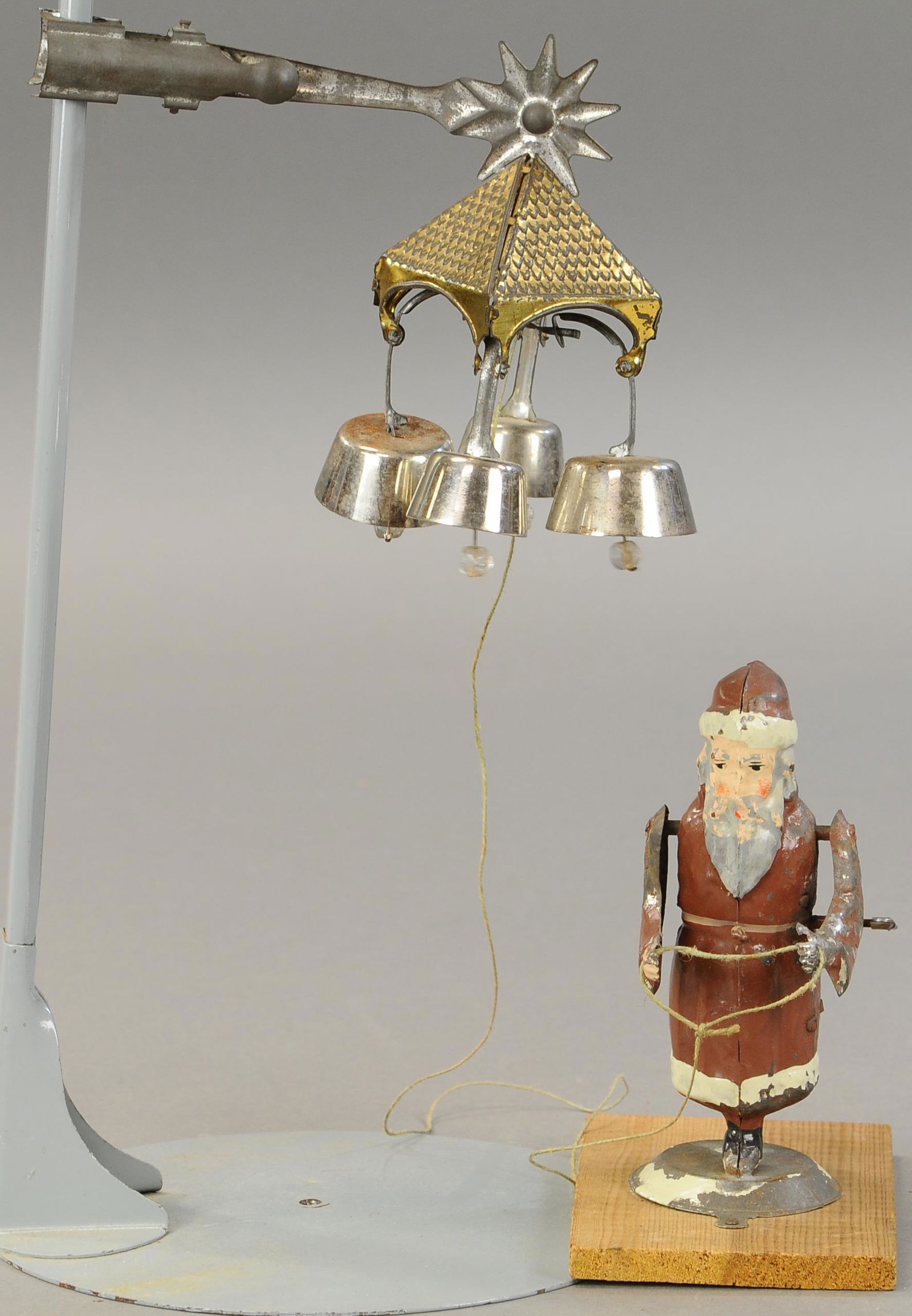 SANTA WITH ANGEL BELLS: 1320. SANTA WITH ANGEL BELLS | Germany, attributed to Gunthermann, fairly scarce toy includes original bells which mount to Christmas tree, when wound, Santa pulls on string to shake and ring the bell