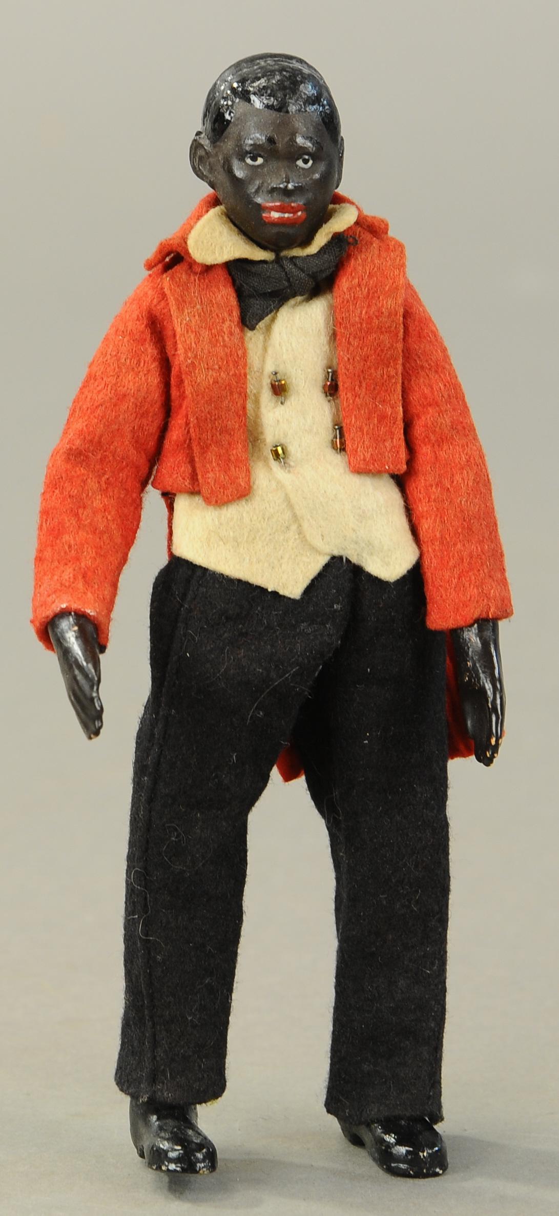 BUCHERER SABA FIGURE BLACK WAITER: 1338. BUCHERER SABA FIGURE BLACK WAITER | A. Bucherer & Cie, Switzerland, circa 1925, metal fully jointed figure with composition head, hands and molded shoes, dark brown painted head with molded blac