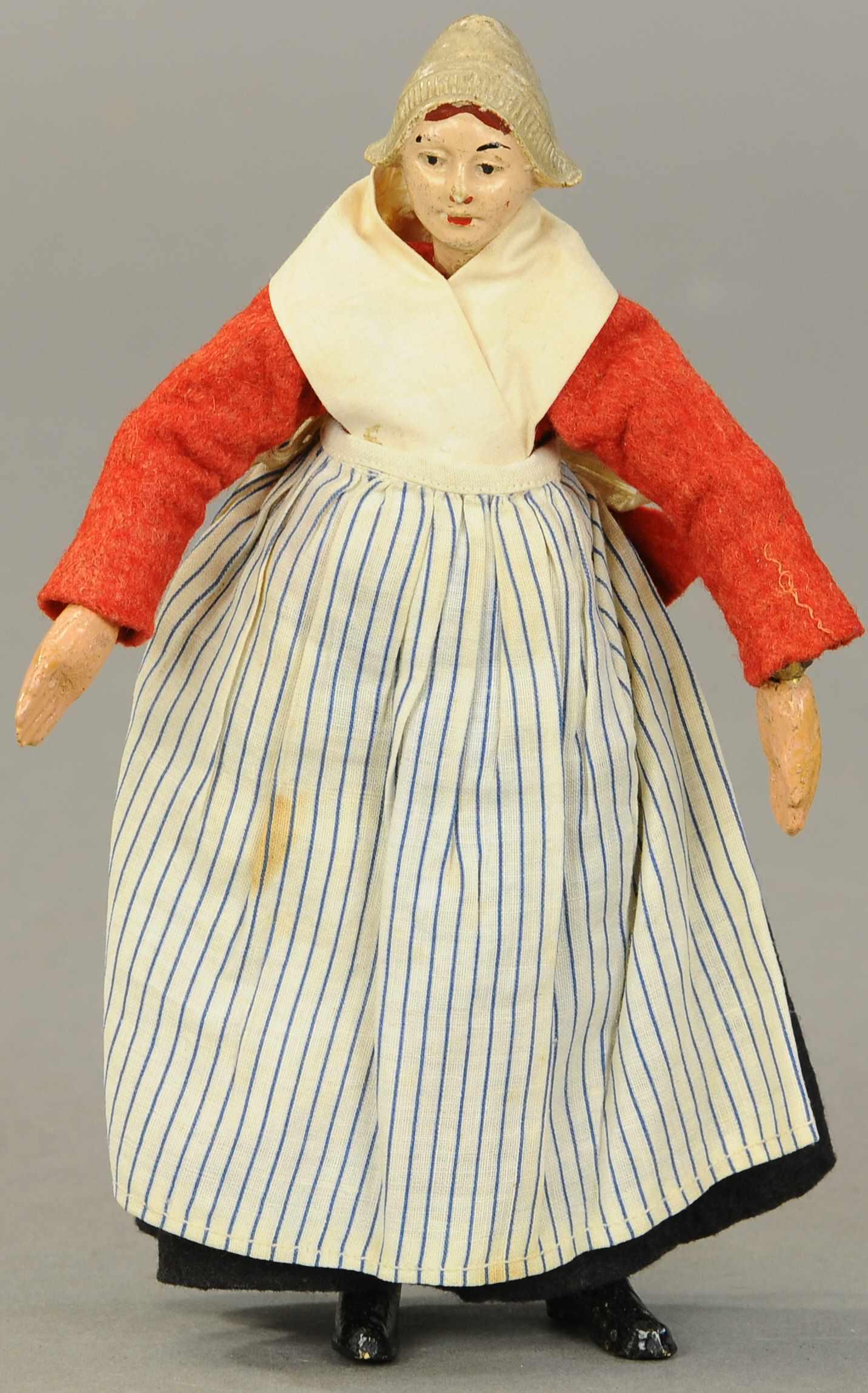 BUCHERER SABA FIGURE DUTCH GIRL WITH MOLDED HAT: 1353. BUCHERER SABA FIGURE DUTCH GIRL WITH MOLDED HAT | A. Bucherer & Cie, Switzerland, circa 1925, metal fully jointed figure with composition head, hands and molded boots, head with molded Dutch sty