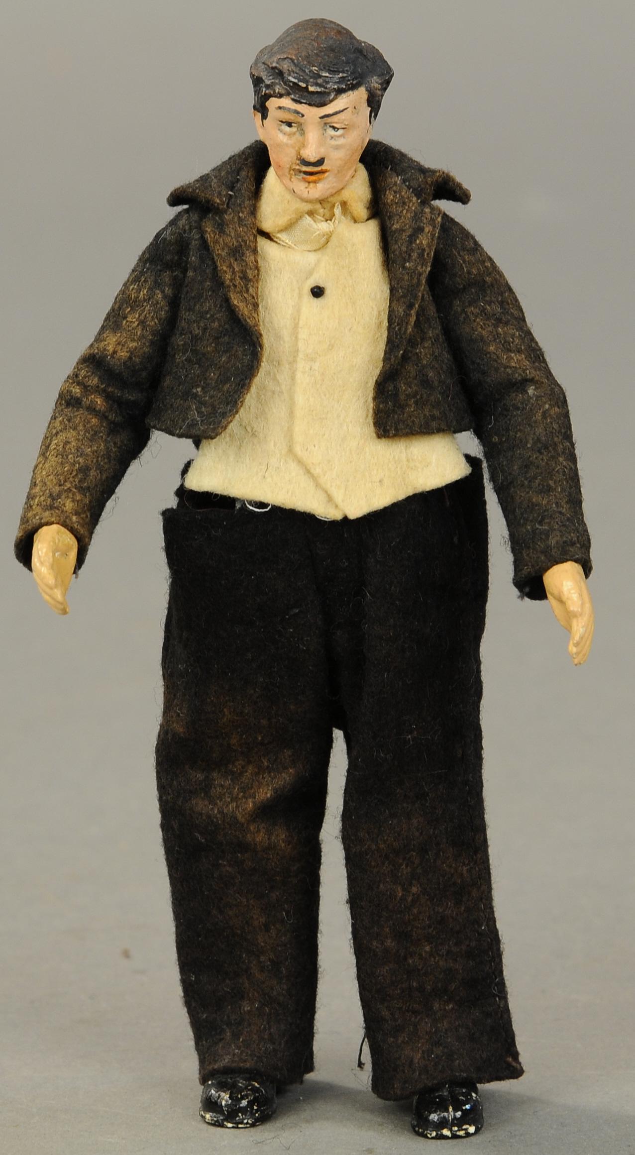 BUCHERER SABA CHARLIE CHAPLIN FIGURE - NO HAT VERS: 1410. BUCHERER SABA CHARLIE CHAPLIN FIGURE - NO HAT VERS | ION A. Bucherer & Cie, Switzerland, circa 1925, metal fully jointed figure with composition head, hands and molded shoes, Charlie Chaplin wea