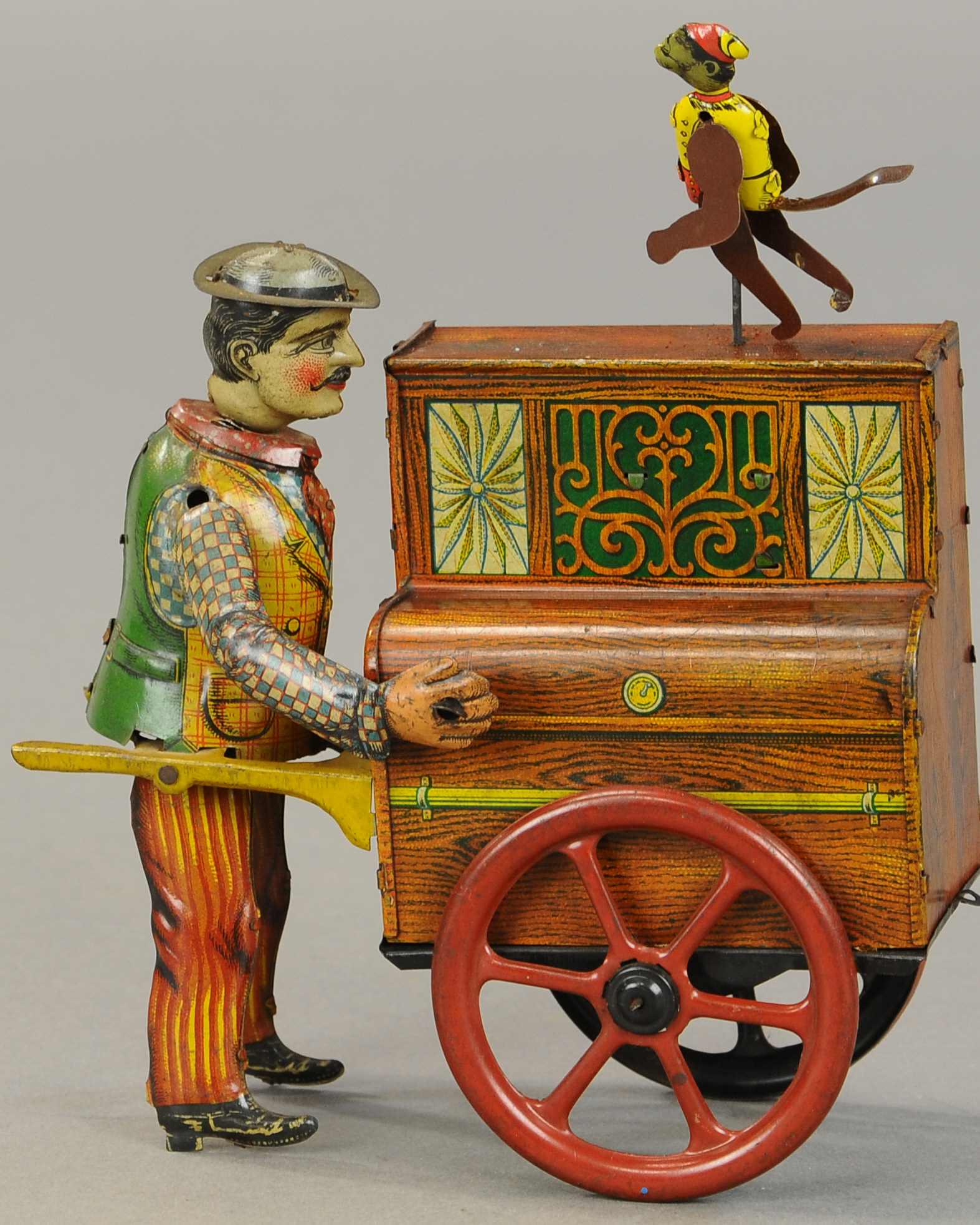 DISTLER WALKING ORGAN GRINDER: 1437. DISTLER WALKING ORGAN GRINDER | Germany, clockwork driven street performer walking organ grinder with dancing monkey. 6.5" h. | Man's left arm and dancing monkey are replaced, otherwise in (Exc.