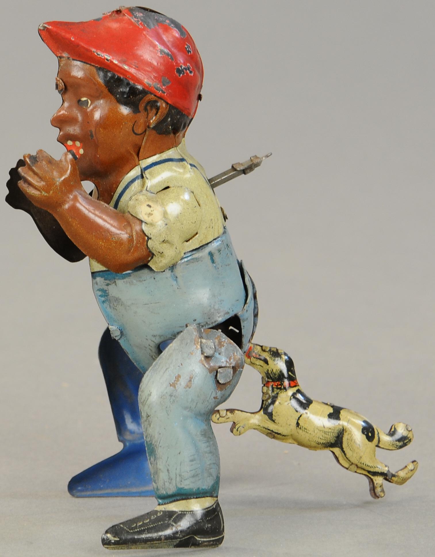 DOG CHASING BLACK BOY TOY: 1441. DOG CHASING BLACK BOY TOY | 6" h. | Common touch-ups to body, likely factory, (Exc. Cond.) | $400 - $600