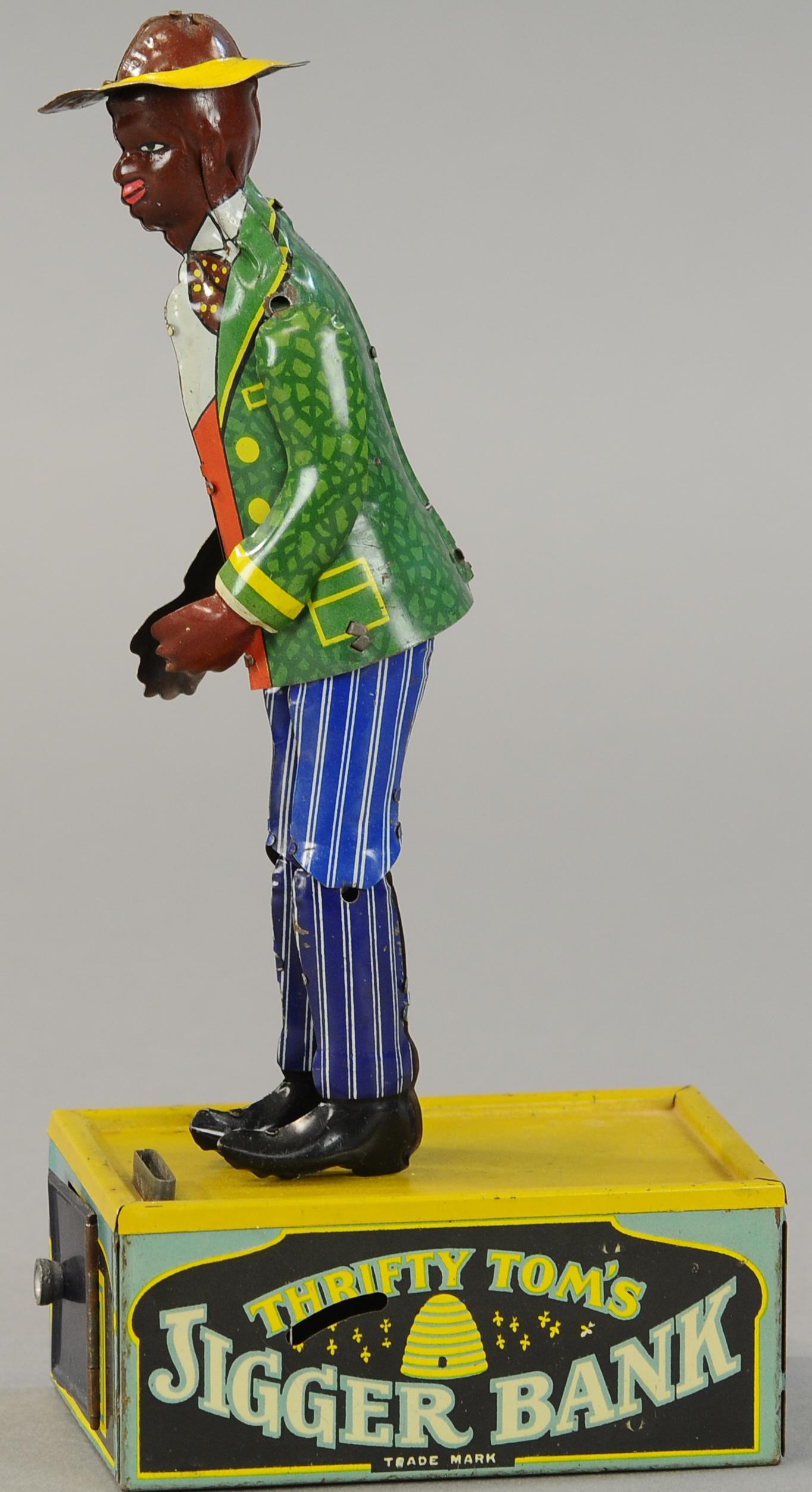 STRAUSS THRIFTY TOM'S JIGGER BANK: 1554. STRAUSS THRIFTY TOM'S JIGGER BANK | Doubles as a wind up toy and a coin saving bank. 10" h. | Start/stop lever missing, but can turn on from inside bank, (Exc.-Pristine Cond.) | $500 - $750