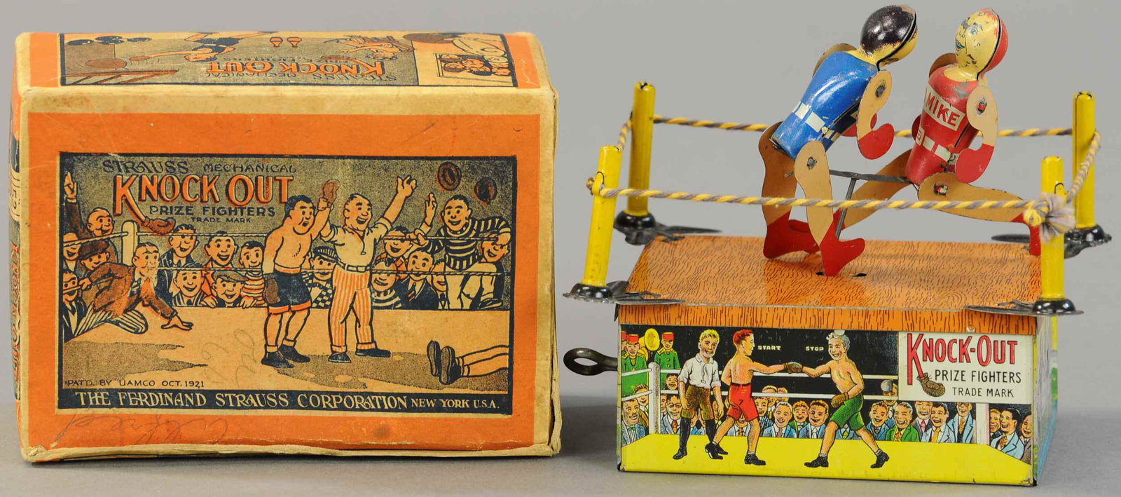 BOXED STRAUSS KNOCKOUT PRIZE FIGHTERS: 1560. BOXED STRAUSS KNOCKOUT PRIZE FIGHTERS | Scarce version with boxer figures wearing red and blue shirts with their names across front; Red Mike and Battling Joe. 6" | (Exc. Cond.) | $300 - $500