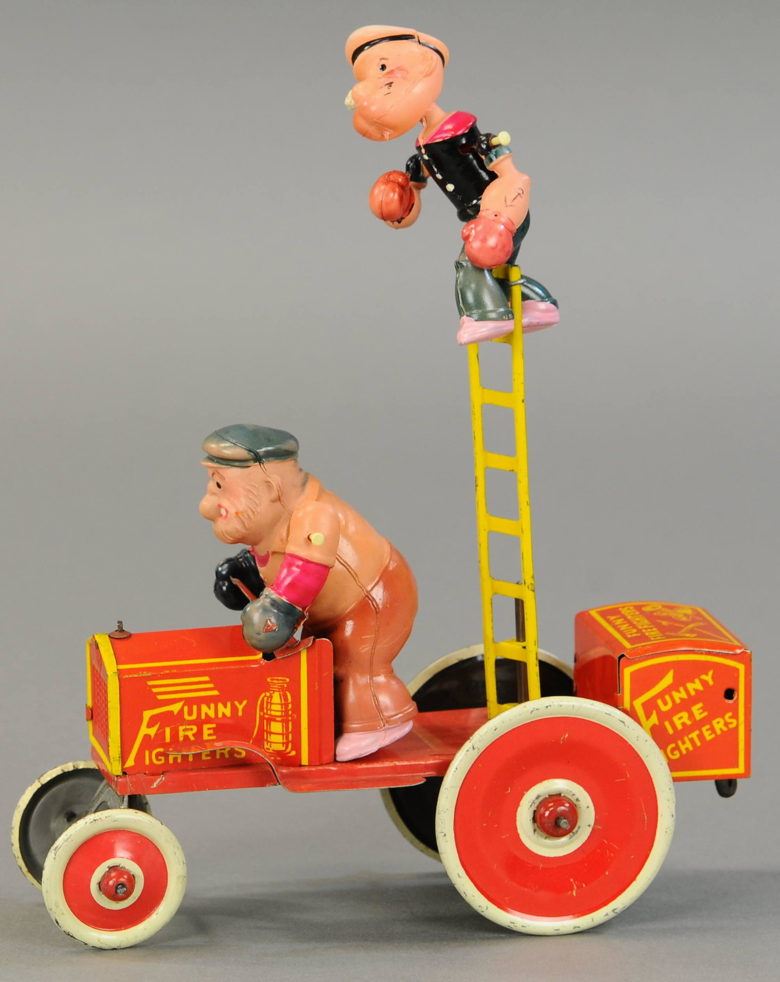 MARX POPEYE & BRUTUS FUNNY FIREFIGHTERS: 1628. MARX POPEYE & BRUTUS FUNNY FIREFIGHTERS | Desirable example, tin and celluloid. 10" | (Pristine Cond.) | $500 - $750