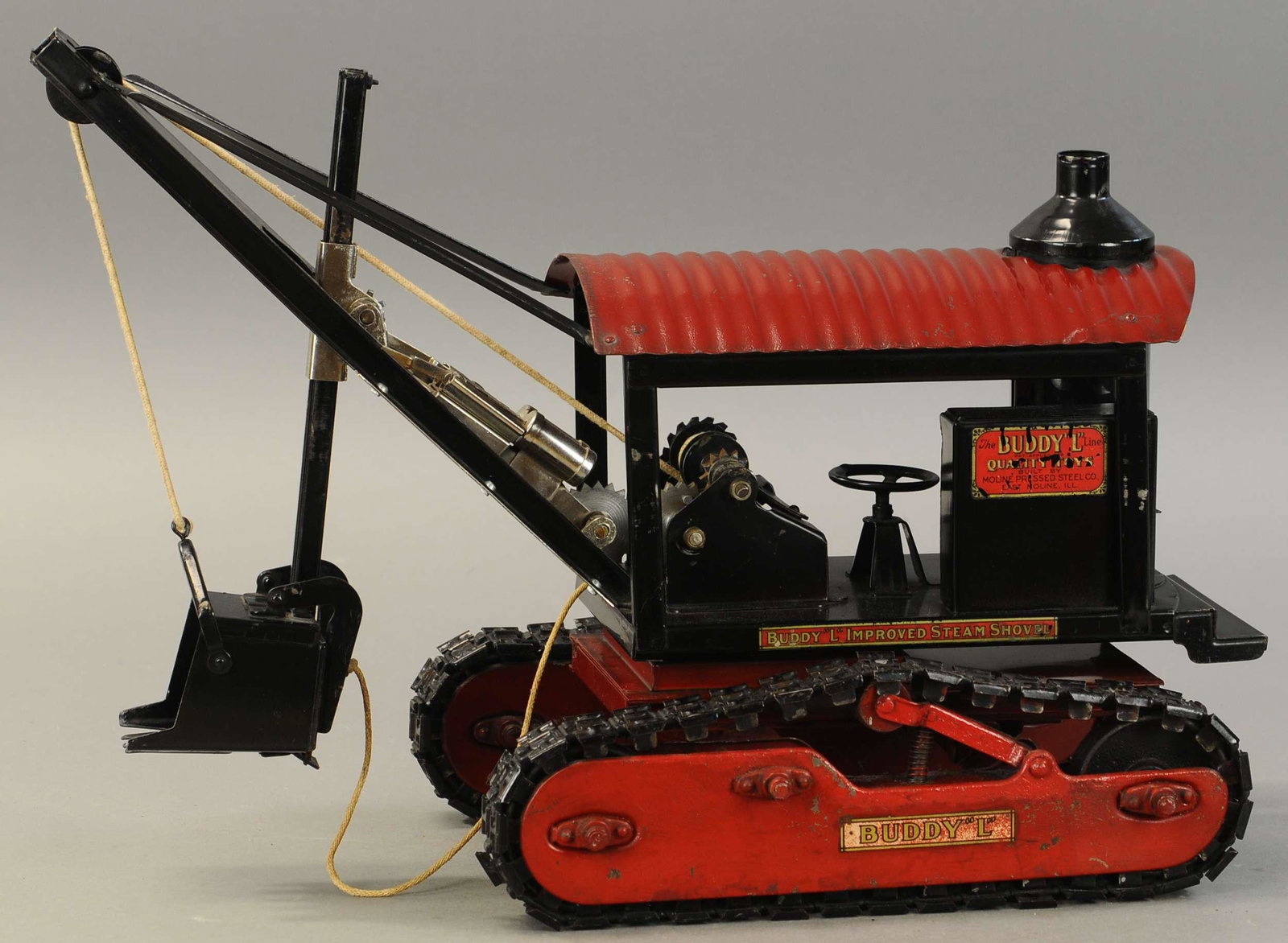 BUDDY L IMPROVED STEAM SHOVEL ON TREADS: 1790. BUDDY L IMPROVED STEAM SHOVEL ON TREADS | A very desirable piece. 22" l. | Top portion of the red on tread frame is overpainted, otherwise in overall (Exc. Cond.) | $2,000 - $3,000
