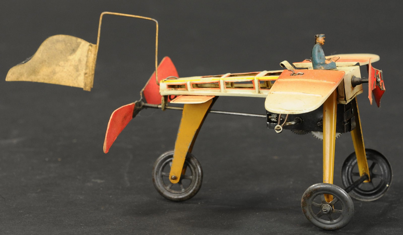 FISCHER BLERIOT W/ FLAPPING WINGS: 2064. FISCHER BLERIOT W/ FLAPPING WINGS | Nice motion as toy is wound up, front propeller spins as side wings seemingly flap. 9" l. | (Exc. Cond.) | $700 - $1,000 | Provenance: Sam Downey Collection.
