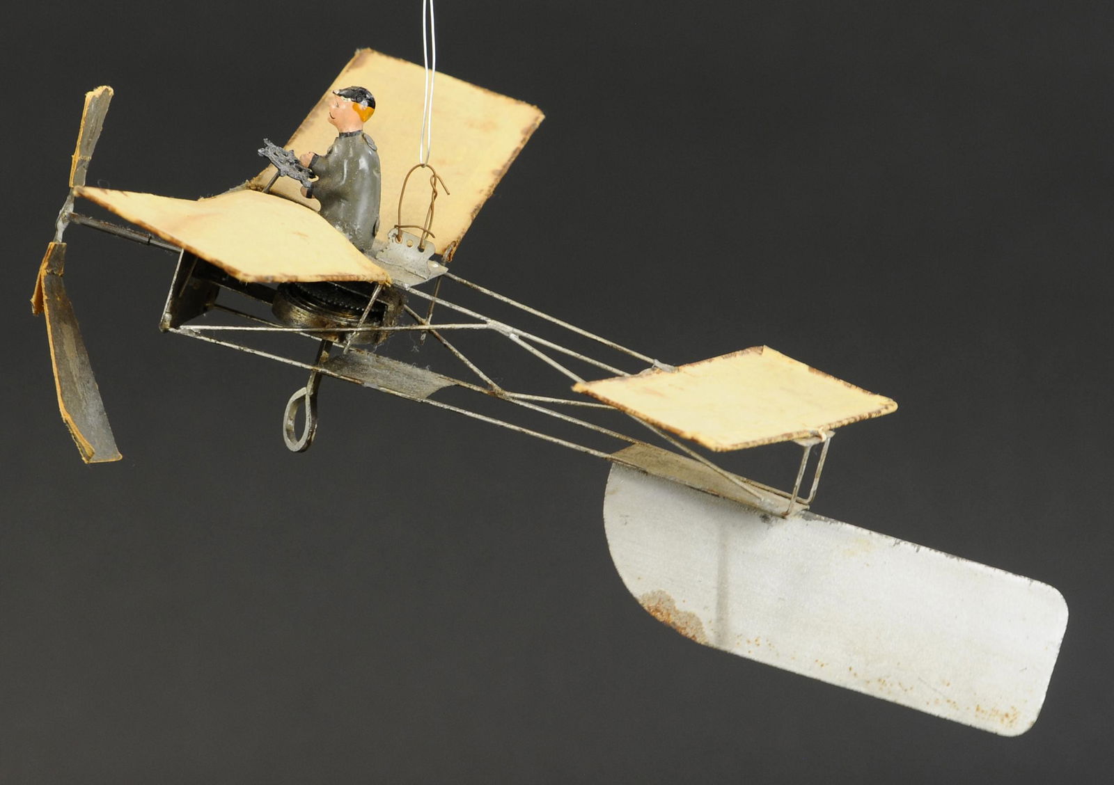 EARLY GUNTHERMANN PLANE: 2068. EARLY GUNTHERMANN PLANE | Wind-up, early plane with exposed metal frame, canvas wings, and large tail rudder. 12" l. | Paper propeller is original, but torn, overall in (Excellent Condition) | $